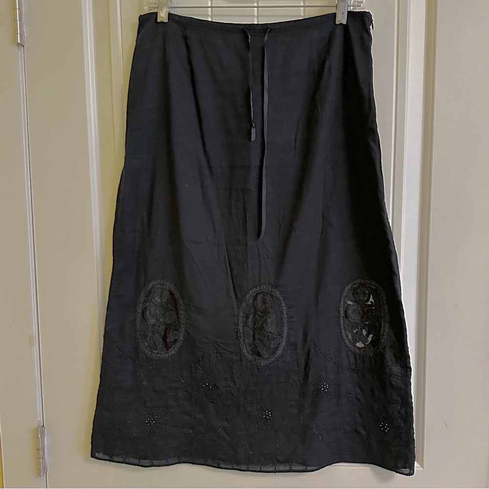 Black a-line skirt with peep hole embroidery design.